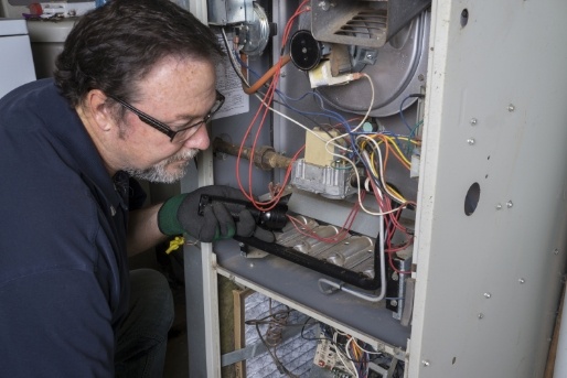 Gallagher's Plumbing, Heating & Air Conditioning - HVAC Technician Installing Furnace