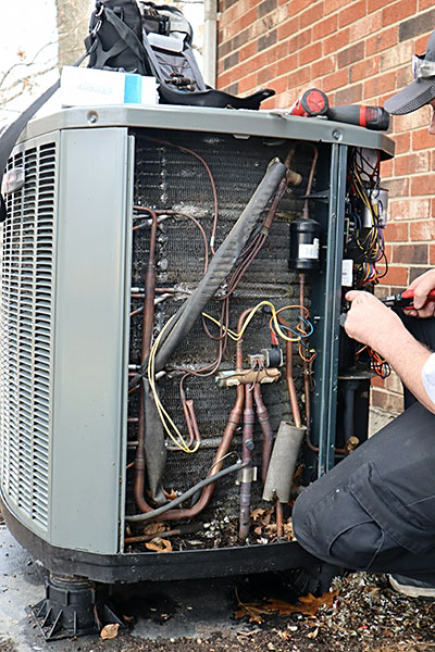 Technician performing heat pump maintenance in Los Molinos, CA